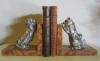 pair of art deco silver plated metal bookends: a King Charles and a cat looking over a wall