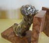 pair of art deco silver plated metal bookends: a King Charles and a cat looking over a wall