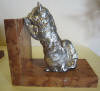 pair of art deco silver plated metal bookends: a King Charles and a cat looking over a wall