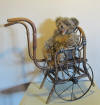 rare doll's chair/cart in bentwood, with caned seat. Iron wheels. Early 1900
