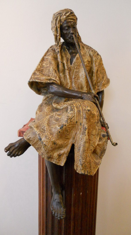 Gaston Leroux: Oriental man with opium pipe on piedestal. late 19th century