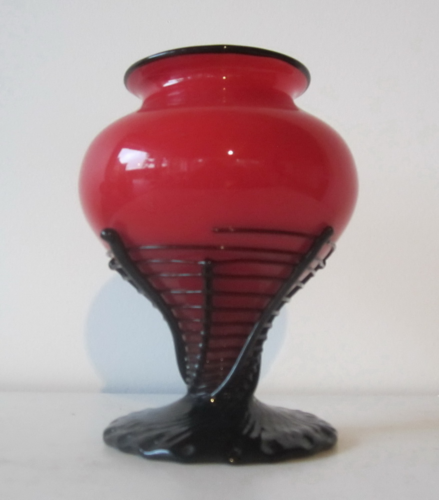 red tango glass spiderweb vase with applied black rim, swirling thread on black glass foo