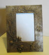 rench bronze picture frame with intricate details with a bird, butterflies and flowers in high relief,