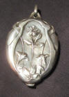 big silver art nouveau sliding mirror pendant.