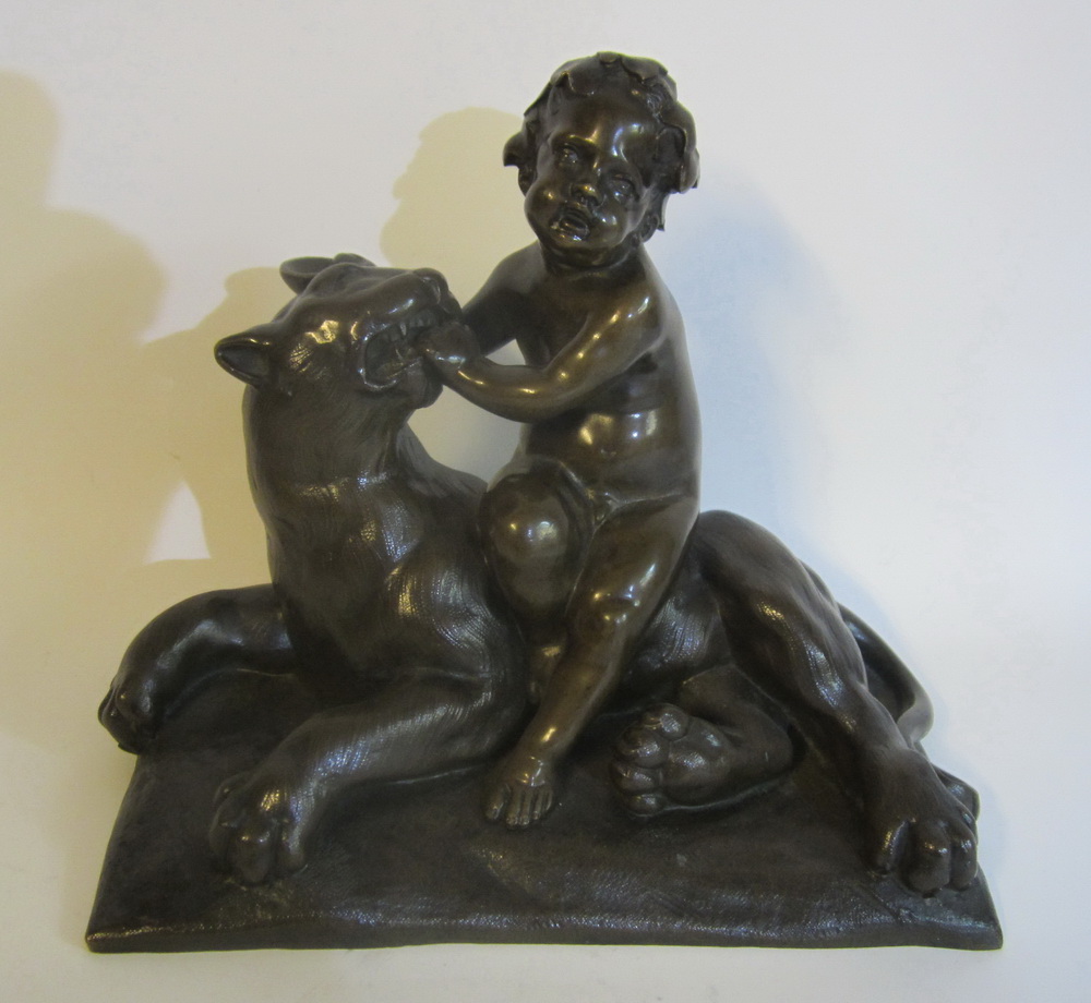 Antique bronze child, playing with a lion or panther; classic bronze. 19th century