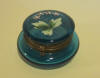 ntique glass pill box with an enameled design of flowers